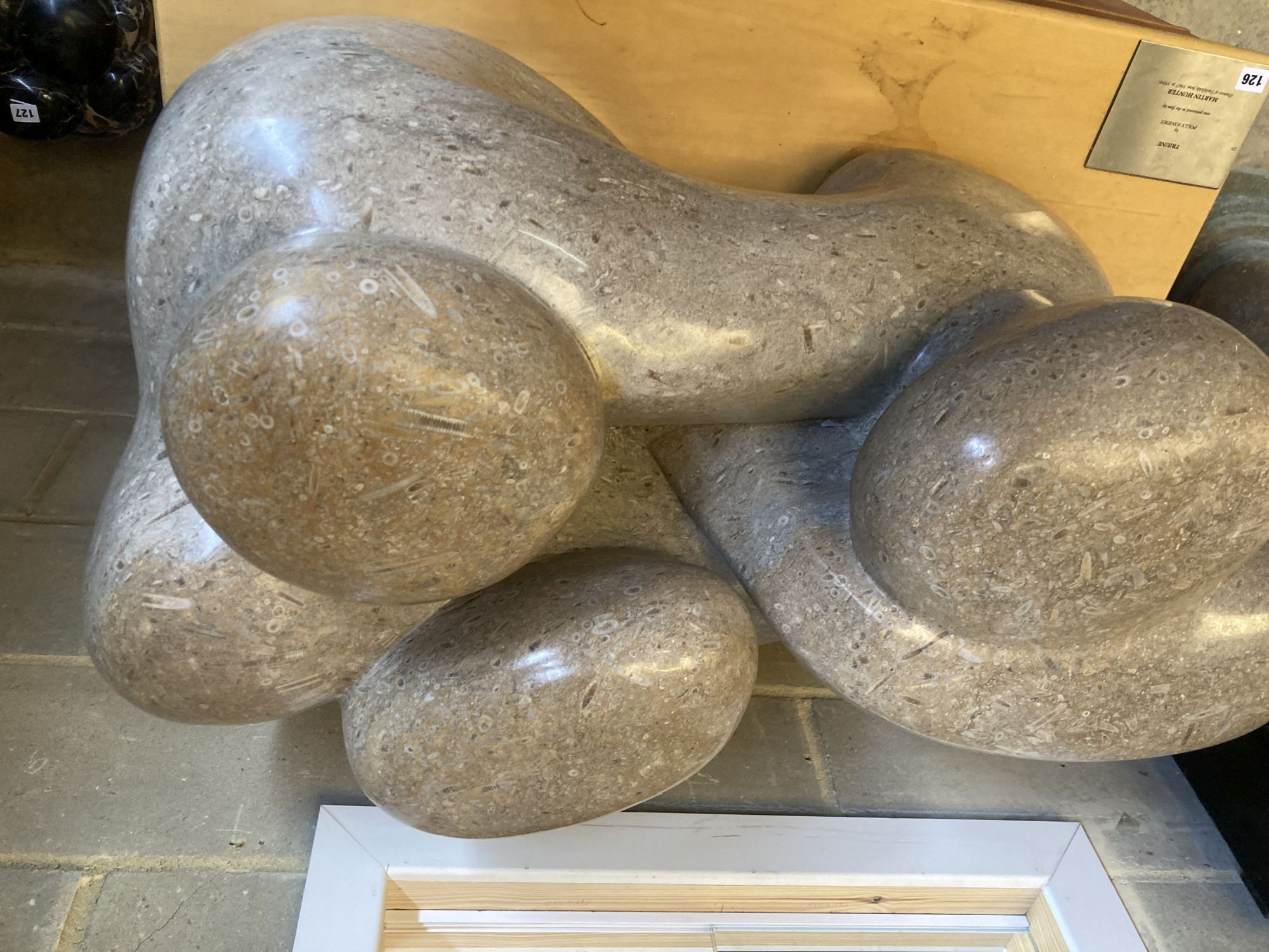 § Polly Ionides (born 1944) Triune, An abstract figural carved limestone group, width 106cm, depth 50cm, height 50cm